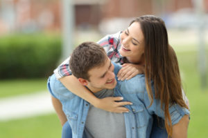 Happy Relationship Couple smiling playful piggyback