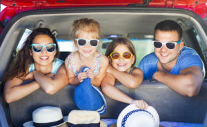 Family of four with sunglasses ready for summer family time